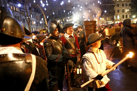  CAPTION CHECK - Members of the Compagnie 1602 take part in a procession in Geneva on December 14, 2014. The annual procession of the Fete de l'Escalade has been held since 1926 and commemorates local resistance to the December 11, 1602 surprise attack by the troops of the Duke of Savoy. A popular symbol of the resistance is the figure of Mere Royaume pouring hot soup from her caldron onto the soldiers. A chocolate replica of the cauldron is widely available during the three-day celebrations. This year marks also the 200-year anniversary of the entry of the Canton of Geneva in the Swiss Confederation. REUTERS/Pierre Albouy (SWITZERLAND)