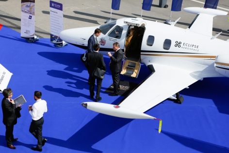  Visitors talk in front of aircrafts in the static display area during the Annual European Business Aviation Convention & Exhibition (EBACE) at Cointrin airport in Geneva May 20, 2014. EBACE, held in Geneva from May 20 to 22, is the flagship forum for the European business aviation community to find products and services from the world's top vendors. REUTERS/Pierre Albouy (SWITZERLAND)